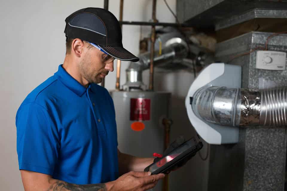 Service technician standing near furnace unit