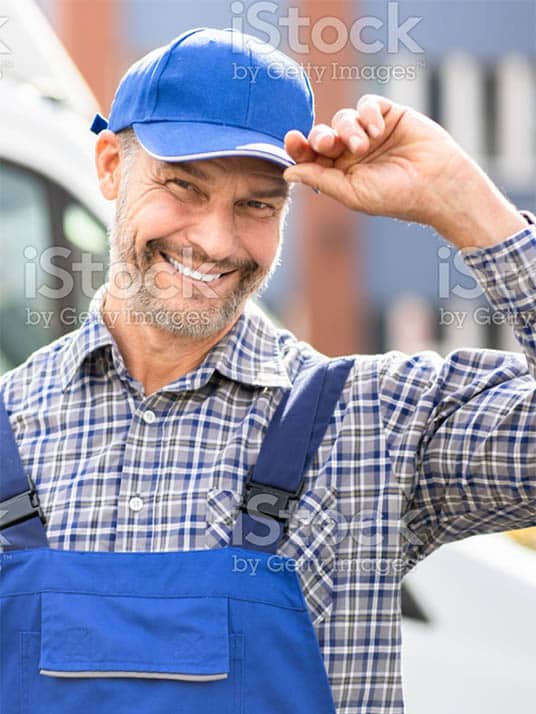 Smiling man tipping his hat respectfully