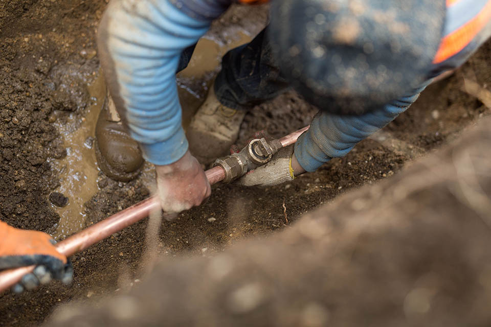 Plumber handling a sewer line